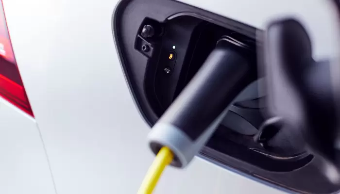 close up of power cable charging electric car